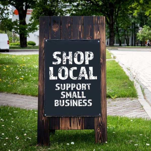 a sign with the text "shop local, support small business"