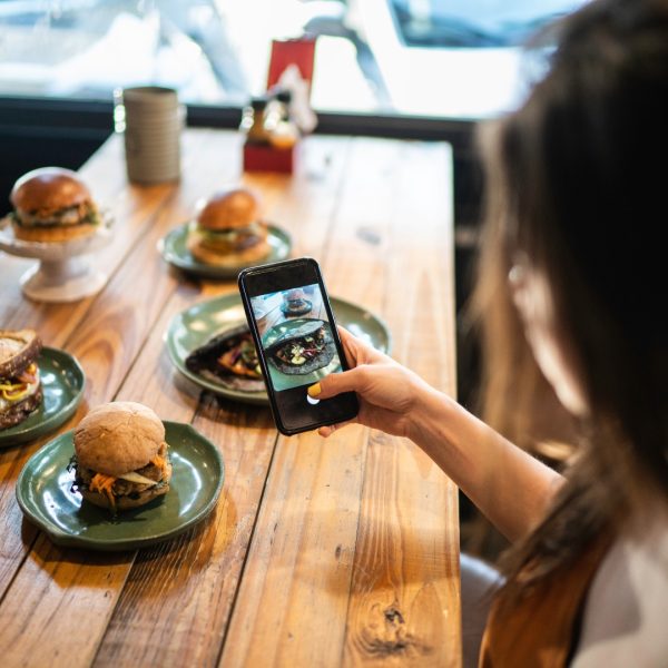 a food influencer is taking photos of food for social media